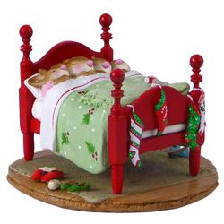 Four sleeping mice in one Christmas bed with stocking