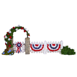 Picket fence with gate and rose covered arch decorate for July 4t