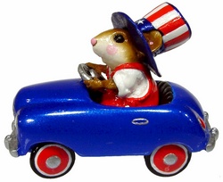 Yankee Doodle driving patriotic peddle car with stars and stipes tophat