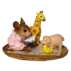 Very young girl mouse reads to her animal toys