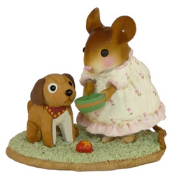 Young girl mouse feeds her stuffed toy dog