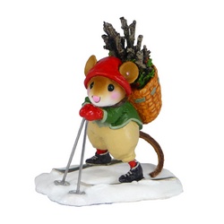 Mouse skier in Elf colors carrying a basket full of firewood