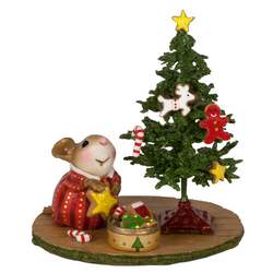 Young girl mouse decorates her tree