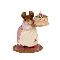 Mother mouse holding birthday cake with a flower candle