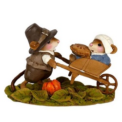 Pilgrim mouse pushes wife and Thanksgiving pie in his wheelbarrow.