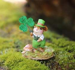 Male mouse dressed for St Patrick's Day holding a clover leaf