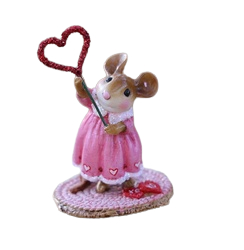 Small female mouse holding up a heart on a stick