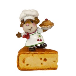 Tiny chef mouse standing on a slice of cheese holding a baked pie