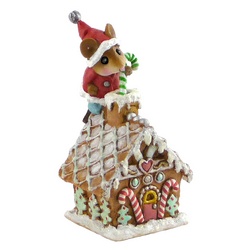 Mouse Santa standing on a Christmas gingerbread house