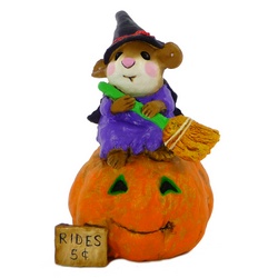 Whitch with broom sits atop of a large pumpkin marked 