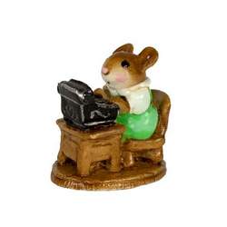 Lady mouse typest working at her desk
