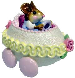 Young mouse in fancy Egg peddle car.