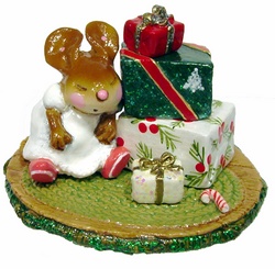 Child mouse sleeping by a stack of Chistmas packages
