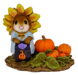 Girl mouse dressed as sunflower hold candies bag next to pumpkins