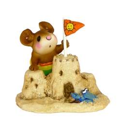 Boy mouse builds sand castle
