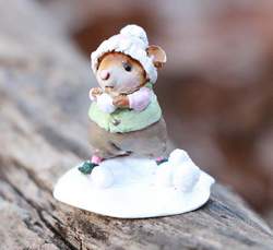 Waiting for her perfect moment, this mouse readies her snowball! 
