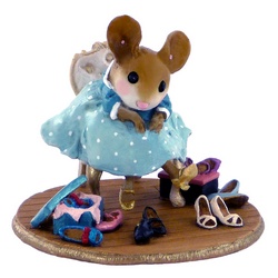 Young female mouse sitting on a chair surrounged by shoes
