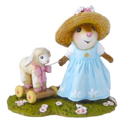 Young girl mouse in a spring dess with a pull along lamb toy