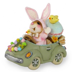 Mouse in Easter rabbit costume driving her car with large egg and chicks