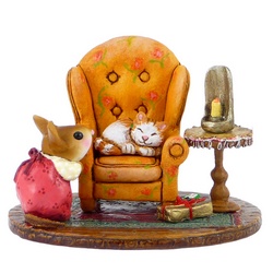 Mother mouse looking a cat in an armchair with candle on table and Xmas gift on floor