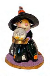 Halloween witch/moiuse holds a Halloween snow globe. 