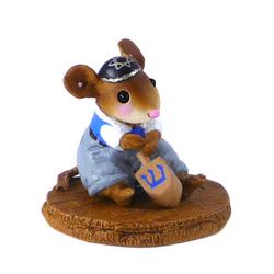 Small boy mouse in a yarmulke and playing with a dreidel