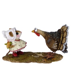 Girl mouse stands in fromt of a turkey with a cob of corn behind her back