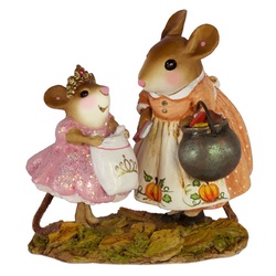 Little princess mouse waits by a mother in Halloween attire holding candies