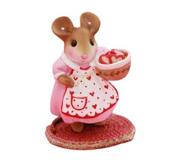 Mother mouse make heart shaped cookies and wears a white apron decorated with hearts!