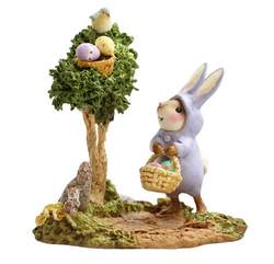 Bunny dressed mouse searches for Easter eggd hidden in a tree.