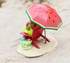 Mother mouse sitting on a beach chair with a watermelon slice and a good book