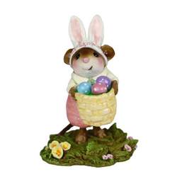 Young female mouse dressed as Easster bunny holding a basket of colored eggs.