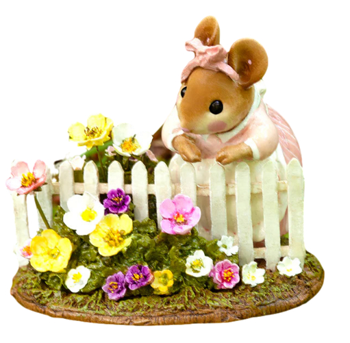 Lady Mouse looking over her garden fence that is covered in flowers