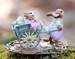 Easter Bunny gives a ride to two young bunnies in a decorated hand cart full of Easter Eggs. Right Side.