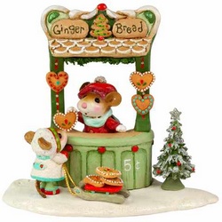 Child mouse stops to fill her sled form the gingerbread cookie stand.