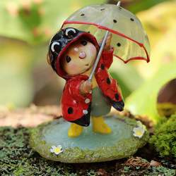 Decked out in a lady bug rain coat this little one is dancing in the rain with a matching umbrella and yellow rain boots to splash in! 