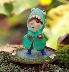 Feeling like the coolest kid in town with his shark raincoat, this little mouse feels the raindrops on his paws as he pauses his splashing to take in the moment. 