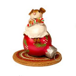 Young mouse with candy cane perched on a Christams ornament
