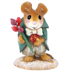 Smart mouse, wearing bowtie and tails stands in the snow holding flowers